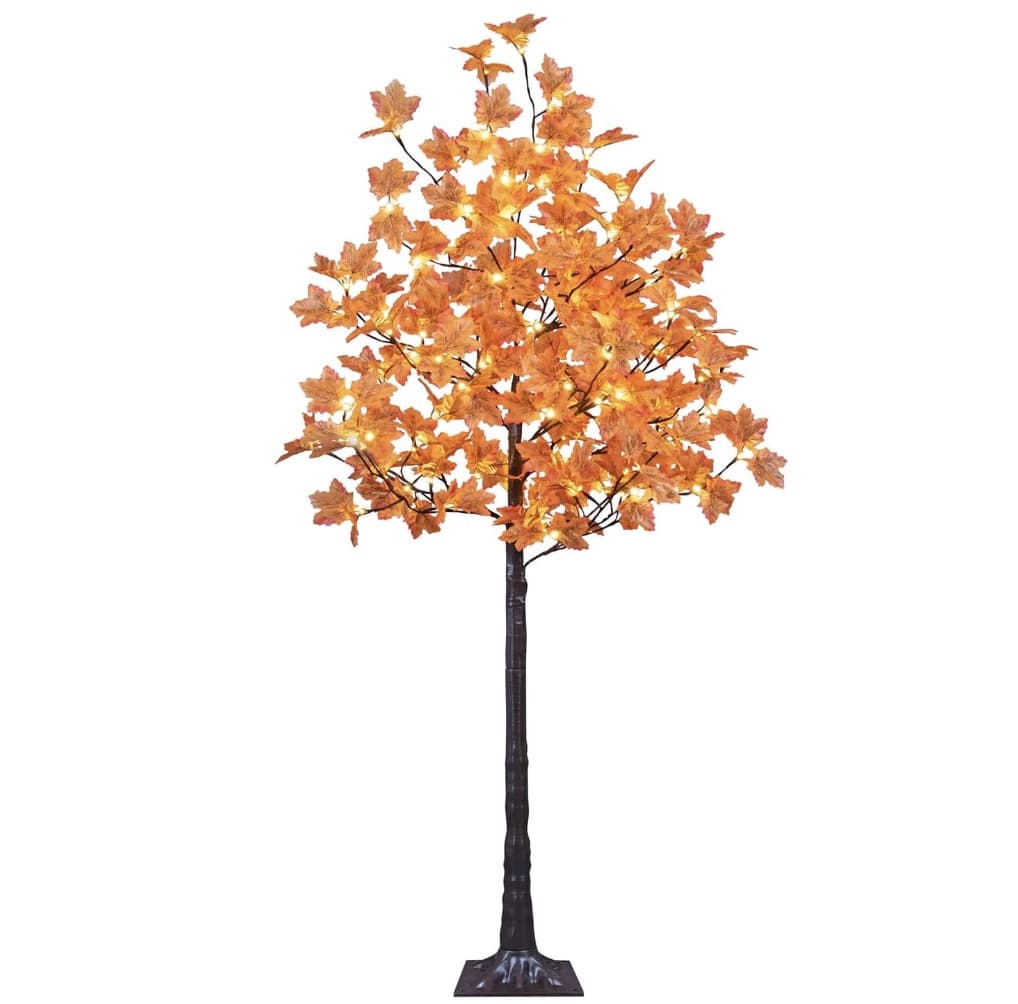 The illuminated artificial tree with orange maple leaves, glowing from warm lights, offers a perfect addition to fall decorating ideas. Standing on a square black base, it resembles a charming decorative piece for both indoor and outdoor settings.